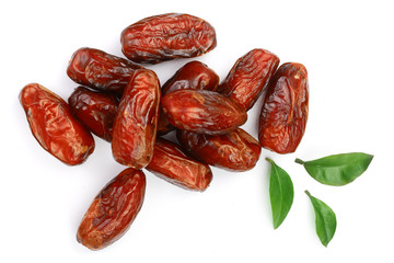 dry dates with green leaves isolated on white background. Top view. Flat lay pattern