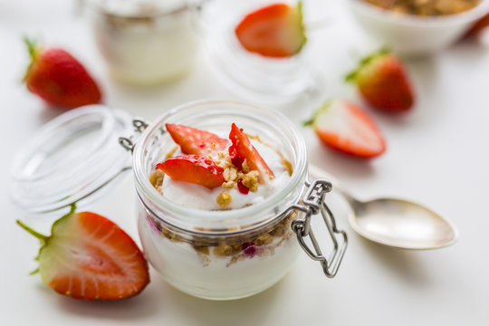 Delicious yogurt with e fresh strawberries and granola.
