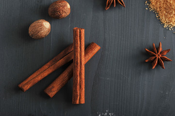 In the frame, cinnamon sticks, nutmeg, cane sugar and anise. Spices for cooking homemade cookies....