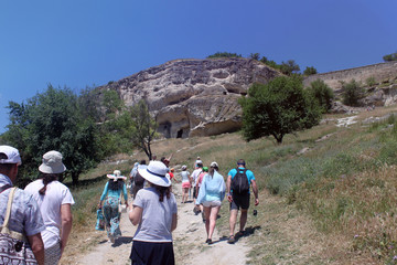 Fototapeta na wymiar Climbing the mountain of tourists, the cave city of Chufut-Kale, Crimea, Russia.