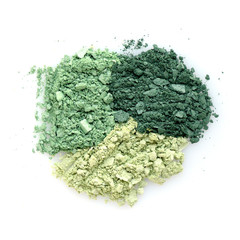 Mixed color eye shadow crushed samples on white background. Top view