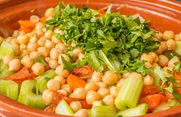 Fresh vegetables and cilantro in a tagine