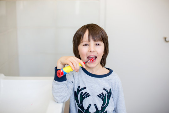 Preschool boys, brushing their teeth in bathroom