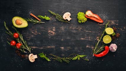 The background of cooking. A set of spices and fresh vegetables. Top view. Free space for your...