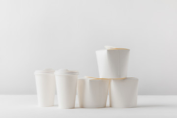 take away boxes and coffee in paper cups on white table