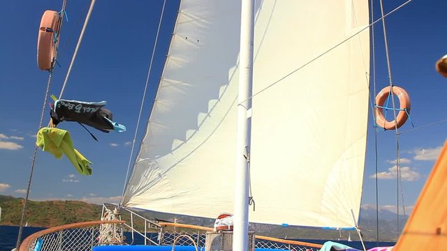 Upper deck of Turkish design Gulet yacht sailing during Blue Cruise Tour against dark blue sky in Turkey. South Western coast of Turkey has crystal clear waters and the many solitary bays