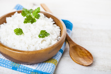 Boiled rice in a wooden bowl and spoon