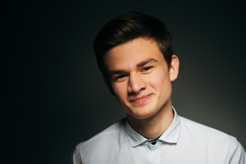 young brunette guy in a white shirt