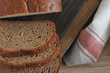 A few slices of bread on a wooden board. Fabric napkin. A few slices of bread on a wooden board....