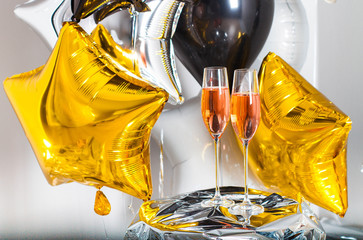 Champagne glasses with rosses drink. With Balloons Celebrating At Party.