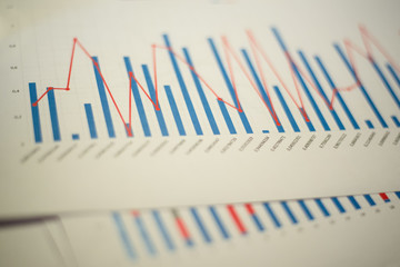Business charts printed on sheets of paper during a meeting. Report with data and numbers