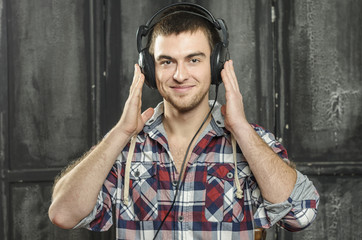 Portrait of a Cowboy. dark hair, jeans , plaid shirt.