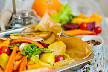 Baked and stewed vegetables on a baking sheet, mix of vegetables, the concept of healthy food and harvest.