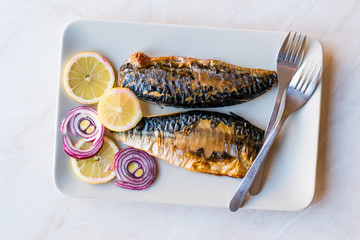 Mackerel Fish with Onions and Lemons in Plate.