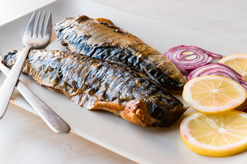 Mackerel Fish with Onions and Lemons in Plate.