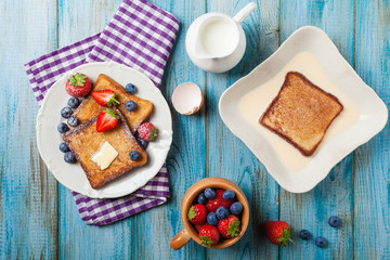 Traditional, delicious, sweet French toast with fruit and butter.