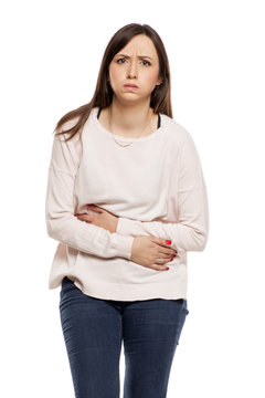 Young Woman With Stomach Pain On White Background