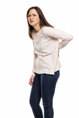 young woman with back pain on white background