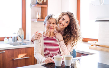A teenage girl with grandmother at home.