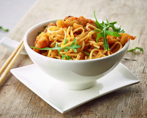 Bowl of asian noodles with fried meat