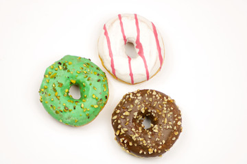 three colorful donuts isolated on white background
