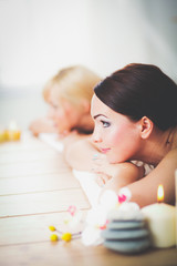Obraz na płótnie Canvas Two young beautiful women relaxing and enjoying at the spa. Two young beautiful women relaxing