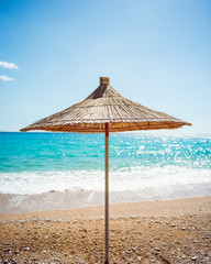 A lonely beach sunshade on a beach in Albania with the sea on the background. Photo taken in the summer of 2017.