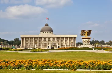 The building of the Government of Sharjah and the Monument of the Koran. Central square. Sharjah. United Arab Emirates