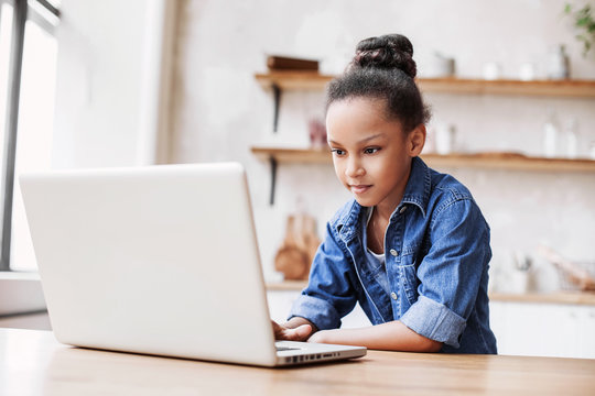 Cute little girl using laptop at home, Education, online study, home studying, distance learning, homework, schoolgirl children lifestyle concept