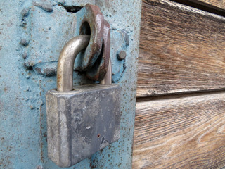 Old metal padlock on locked doors. Home security concept