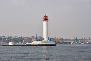 Odessa, Ukraine - August 25, 2016: View on beautiful white lighthouse - symbol of Odessa, Ukraine. Port, Black Sea and lighthouse.