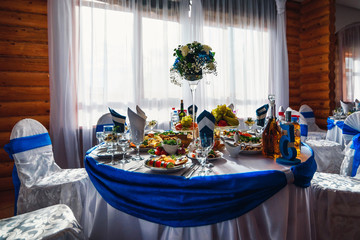 table with food and drinks in the restaurant beautifully decorated for a festive wedding dinner at a Banquet