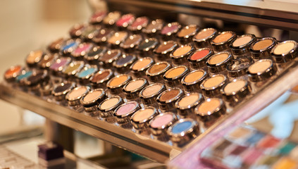 A lot of colorful makeup attributes in a store on the market