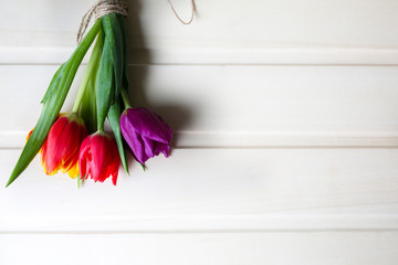 Tulips on wooden background. Perfect invitation for mother's day or international women's day. Minimalist spring flower background for advert and promotion. Summer postcard. Vertical photo.