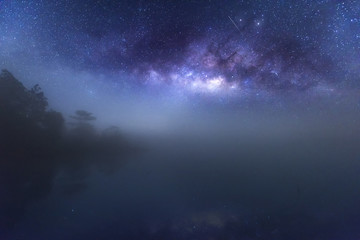Naklejka na ściany i meble Milky way with misty water reflection, Phu Kradueng National Park, Thailand