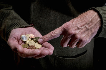 Hands of an elderly person, counting coins