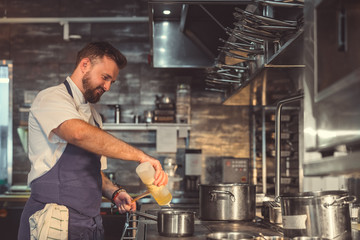 Young chef prepares in the kitchen