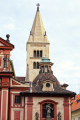 Fototapeta na wymiar White Renaissance tower by the Baroque church facade