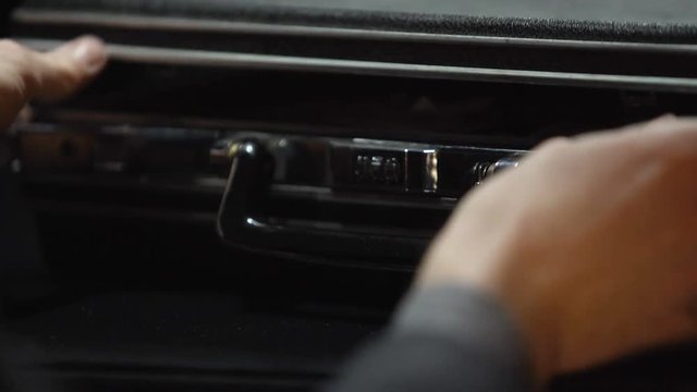 Oligarch hides cash money into suitcase, secret stash, no trust to bank, closeup