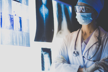 Image of attractive woman doctor looking at x-ray results.