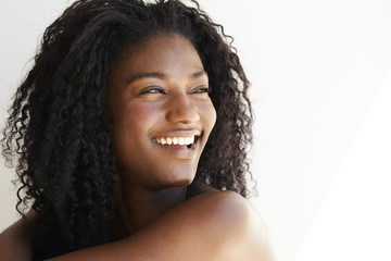 Beautiful woman laughing against white background