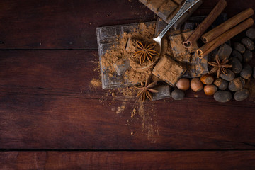 Chocolate, Spices, Spoon with Cocoa on the Wooden Background. Copy space. Flat lay, top view