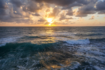 Fantastic stunning colorful sunset by the sea, waves and sunlight