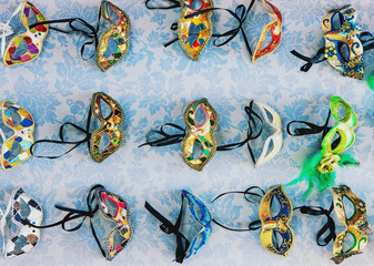 Traditional cheap colorful venetian masks for sale in public market in Venice, Italy