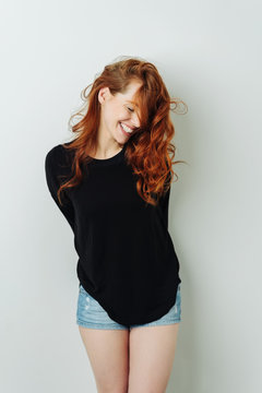 Seductive coy young redhead woman laughing