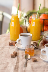 Breakfast with coffee cups, orange juice, makaron the outdoor terrace