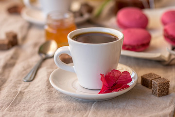 Breakfast with coffee cups, orange juice, makaron the outdoor terrace