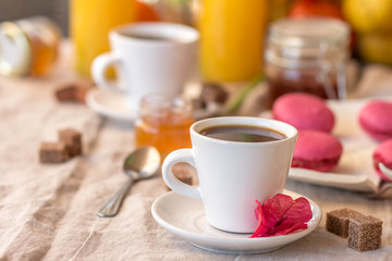 Breakfast with coffee cups, orange juice, makaron the outdoor terrace