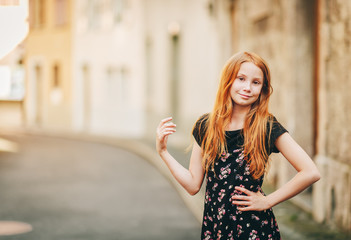 Fototapeta premium Outdoor fashion portrait of happy red-haired girl