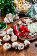 Ingredients ready for prepare tagliatelle pasta with champignon